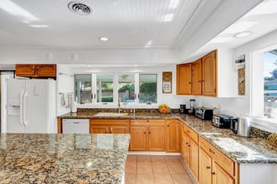 Bright kitchen with wooden cabinets and granite countertops