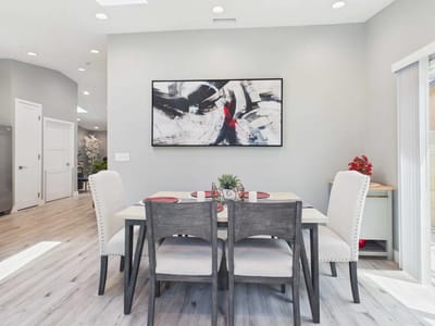 Bright common area with dining table and artwork