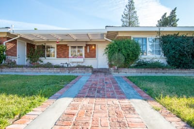 Exterior view of Woodlake Loving Care LLC with pathway