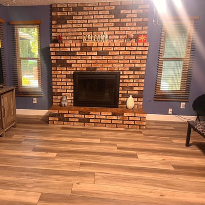 Cozy common area with a welcome sign and brick fireplace