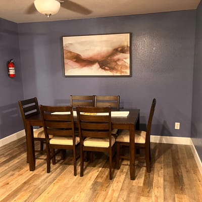 A dining area with a large table and chairs