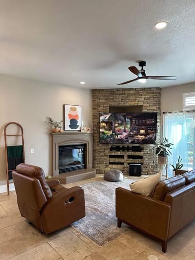 Cozy lounge area with leather chairs and a fireplace