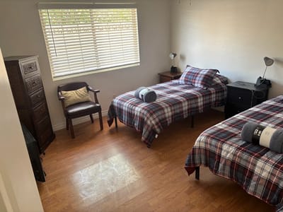 A twin-bedded private resident room with natural light