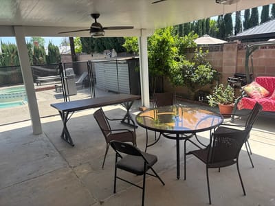 Outdoor patio area with seating and a pool