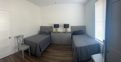 Shared resident room with two beds and lamps
