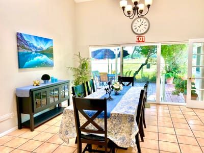 Bright dining room with exit door and outdoor view