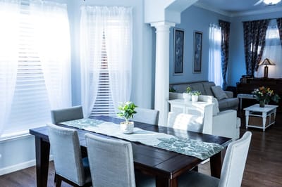 Bright and welcoming common area with seating and dining table
