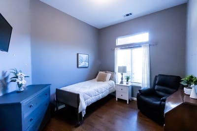 Cozy bedroom with a bed, chair, and desk