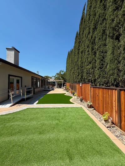 Well-maintained garden area with pathway and trees