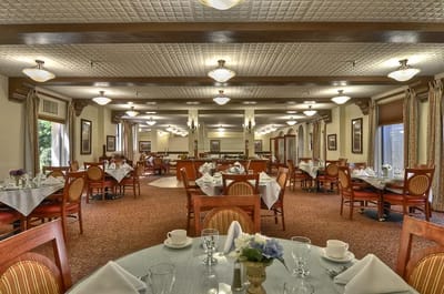 Dining room set up for residents with tables and chairs