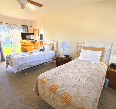 Cozy shared bedroom with two beds and a view