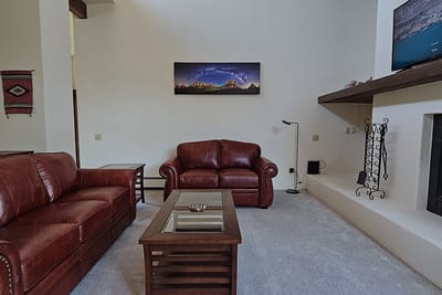 Cozy common area with leather sofas and a TV