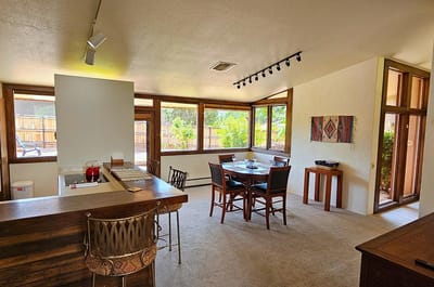 Bright dining area with large windows and tables