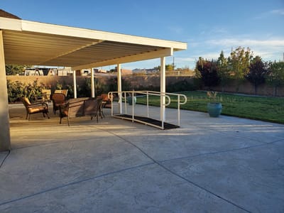 Outdoor patio area with seating and greenery