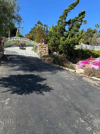 Entrance gate surrounded by gardens and greenery