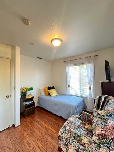Cozy resident room with a bed and sitting area