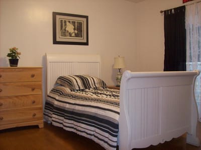 Cozy resident room with a bed and dresser