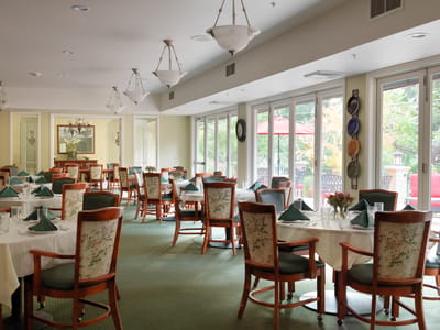Well-furnished dining room with large windows