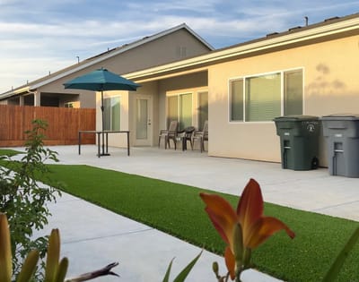 Outdoor patio area with seating and landscaping