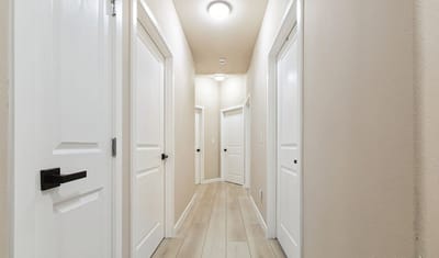 Interior hallway with closed doors and soft lighting