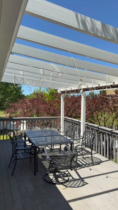 Outdoor seating area with pergola and tables