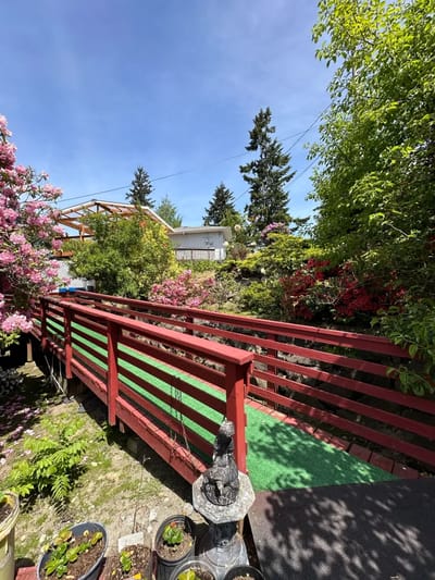 Bridge in a lush garden filled with flowers