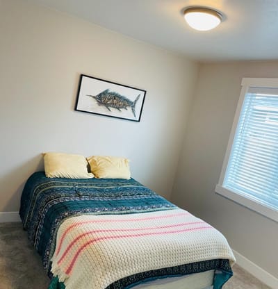 Cozy private resident room with a bed and artwork