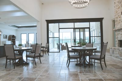 Bright and spacious common area with dining tables