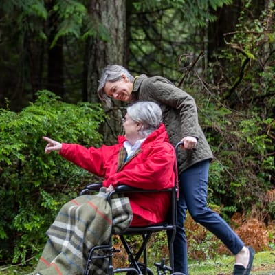 A caregiver and resident enjoying a moment outdoors