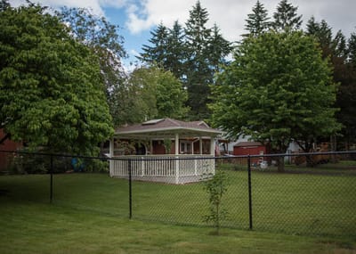 Outdoor gazebo surrounded by green trees