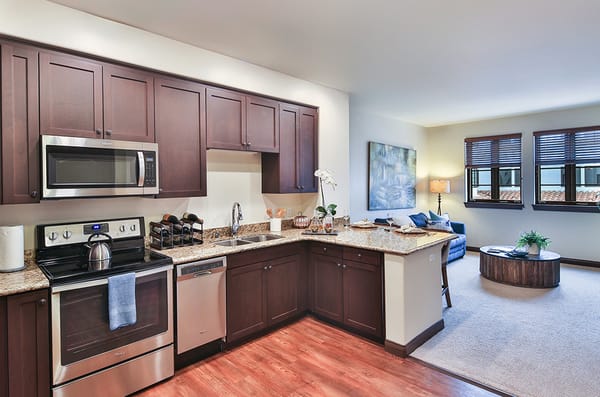 Senior living apartment kitchen with modern appliances and open layout.