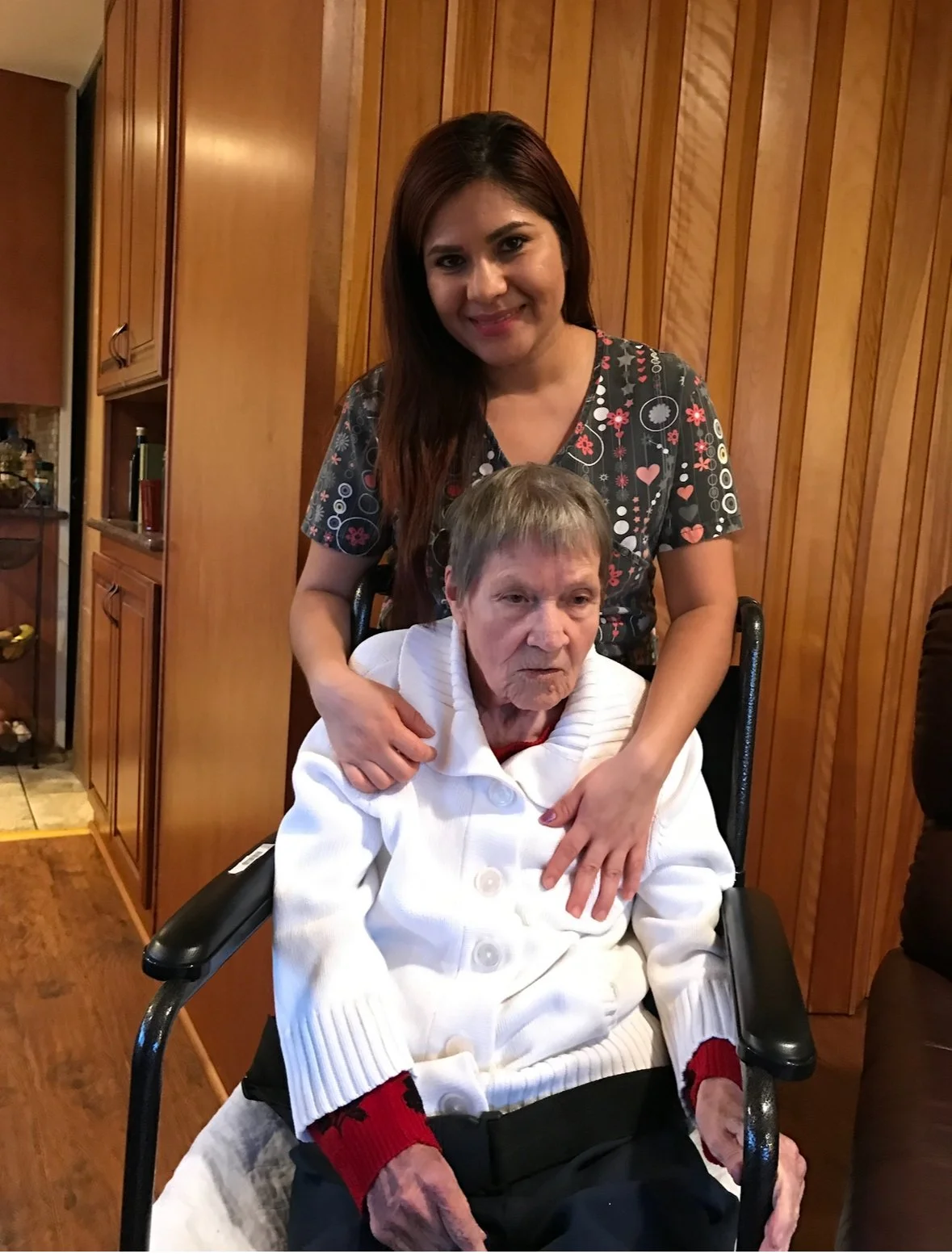 A caregiver with a resident in a home-like setting.