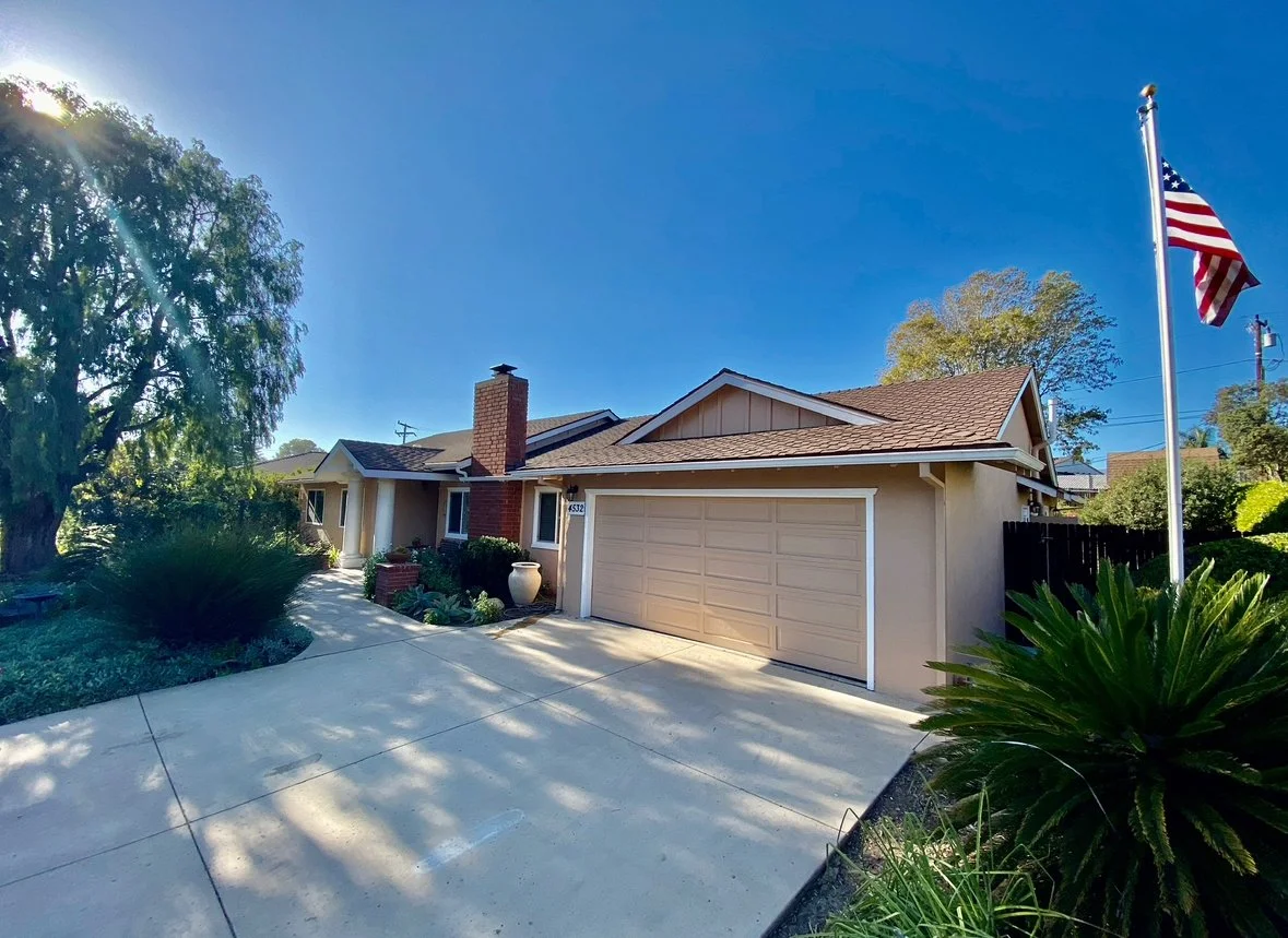 Exterior view of a residential building with landscaping.