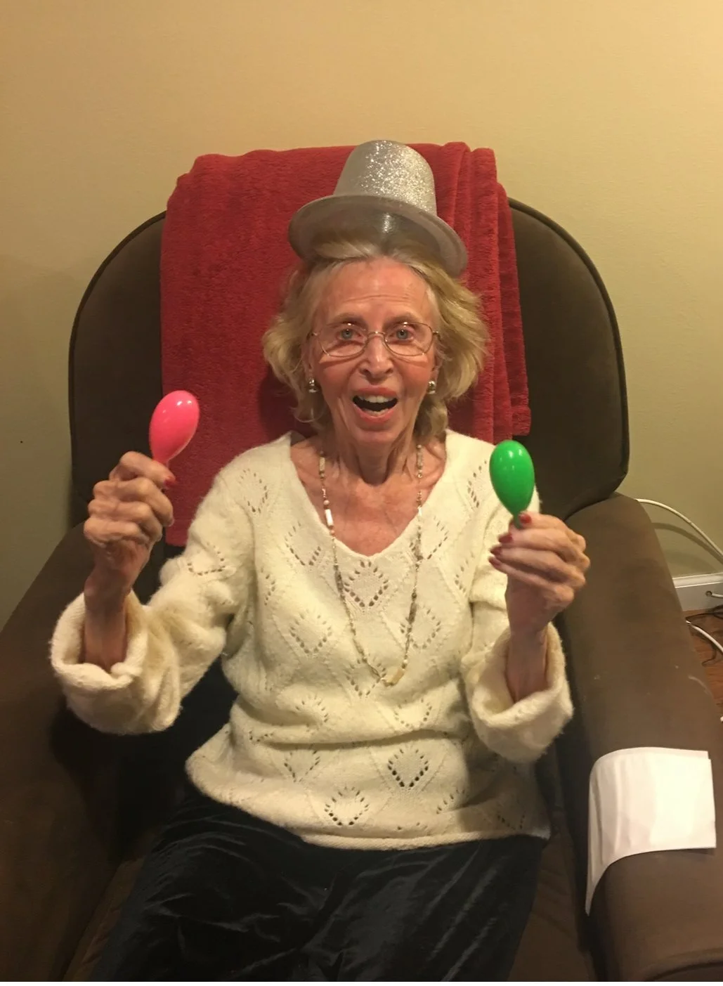 Elderly woman celebrating with maracas