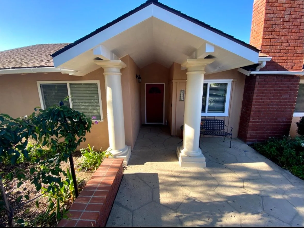 Entrance of a residential building with landscaping.