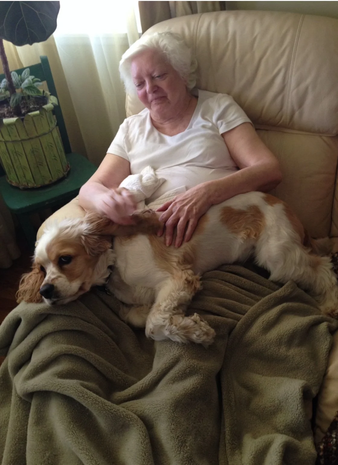 Resident with a dog in a cozy setting.
