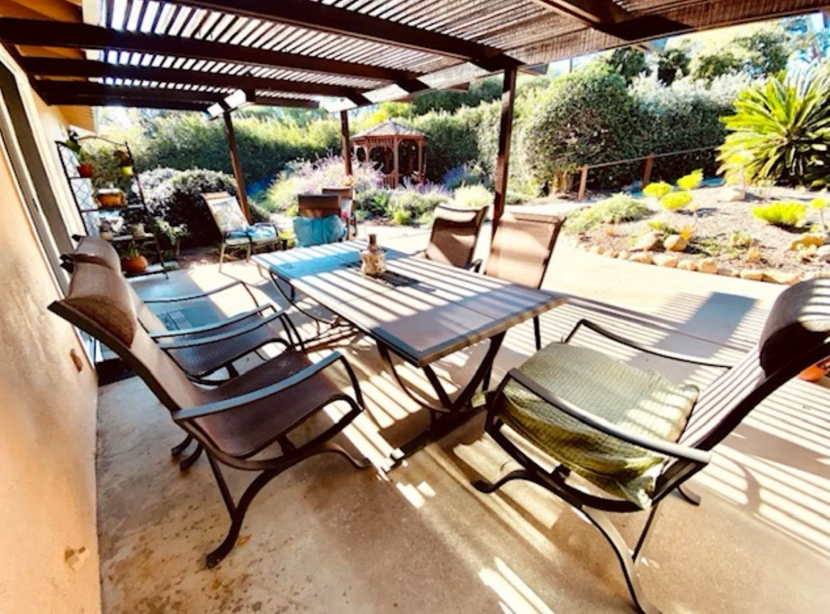 Outdoor seating area with patio furniture and garden view.