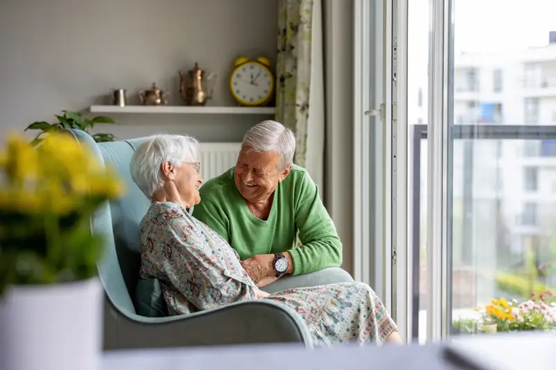 A smiling couple enjoying time together in a cozy living area