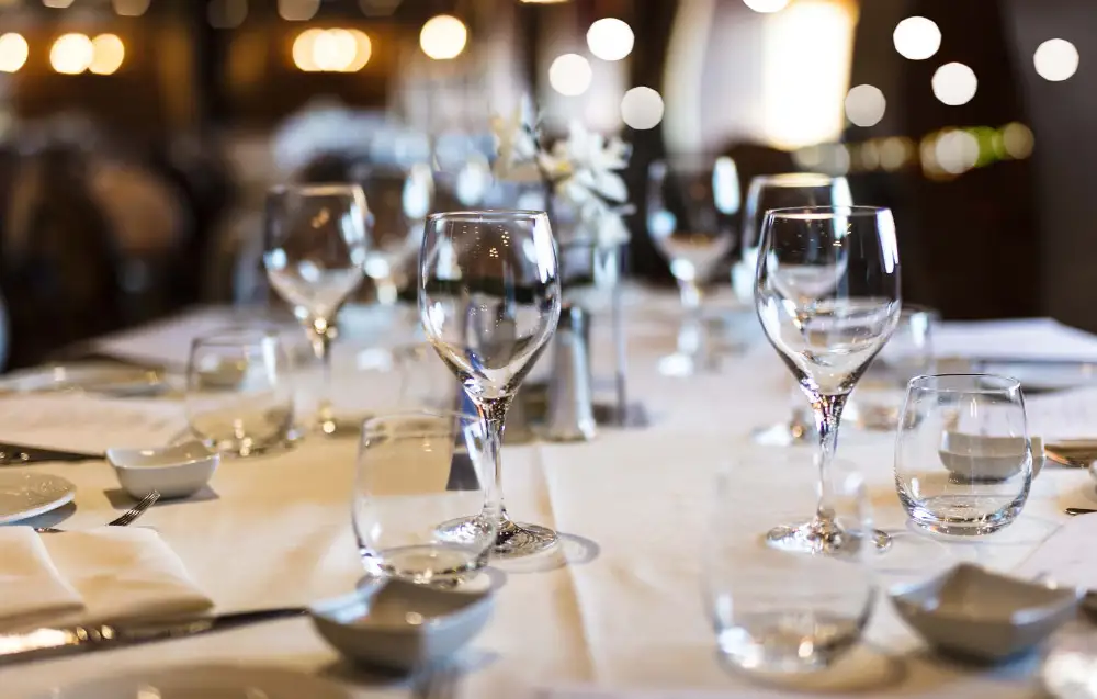 Dining area set with empty glasses and table settings
