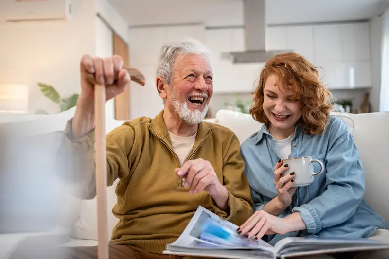 Elderly man and woman enjoying time together in a living room