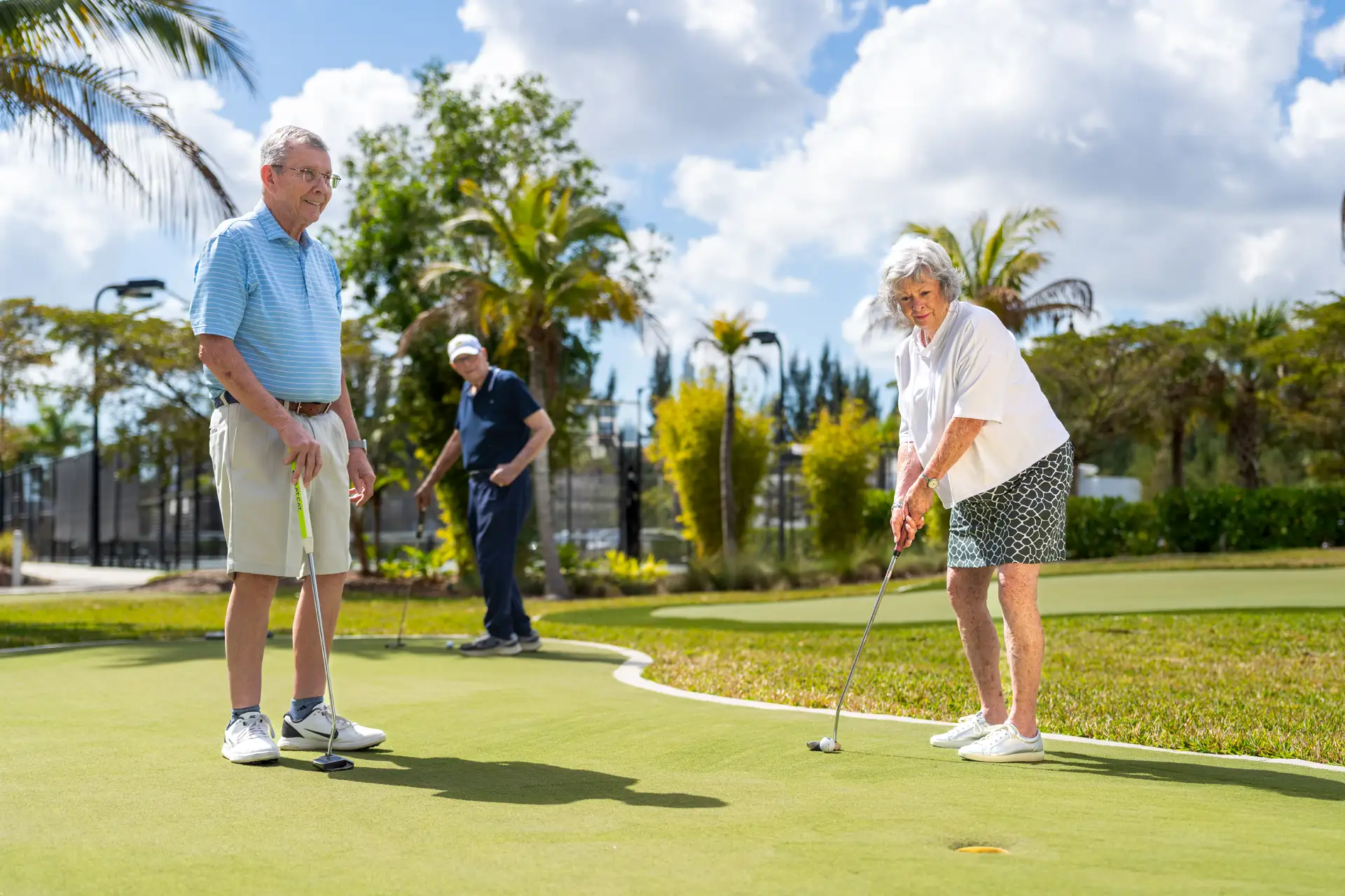 Residents enjoying putting on a green outdoor course