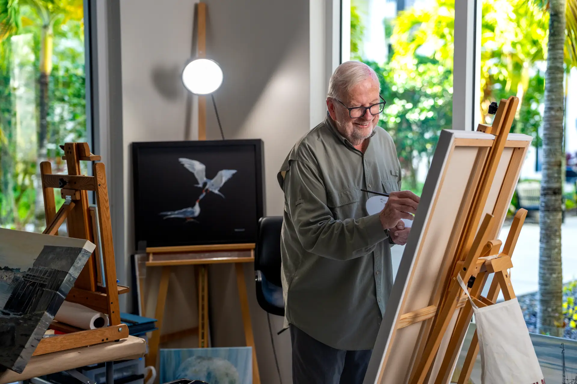 Resident painting in an art activity room