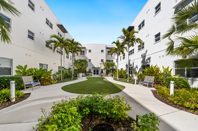 Lush outdoor courtyard with seating and pathways