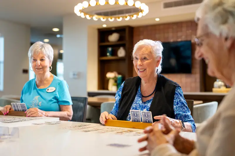Residents playing a card game in a communal area