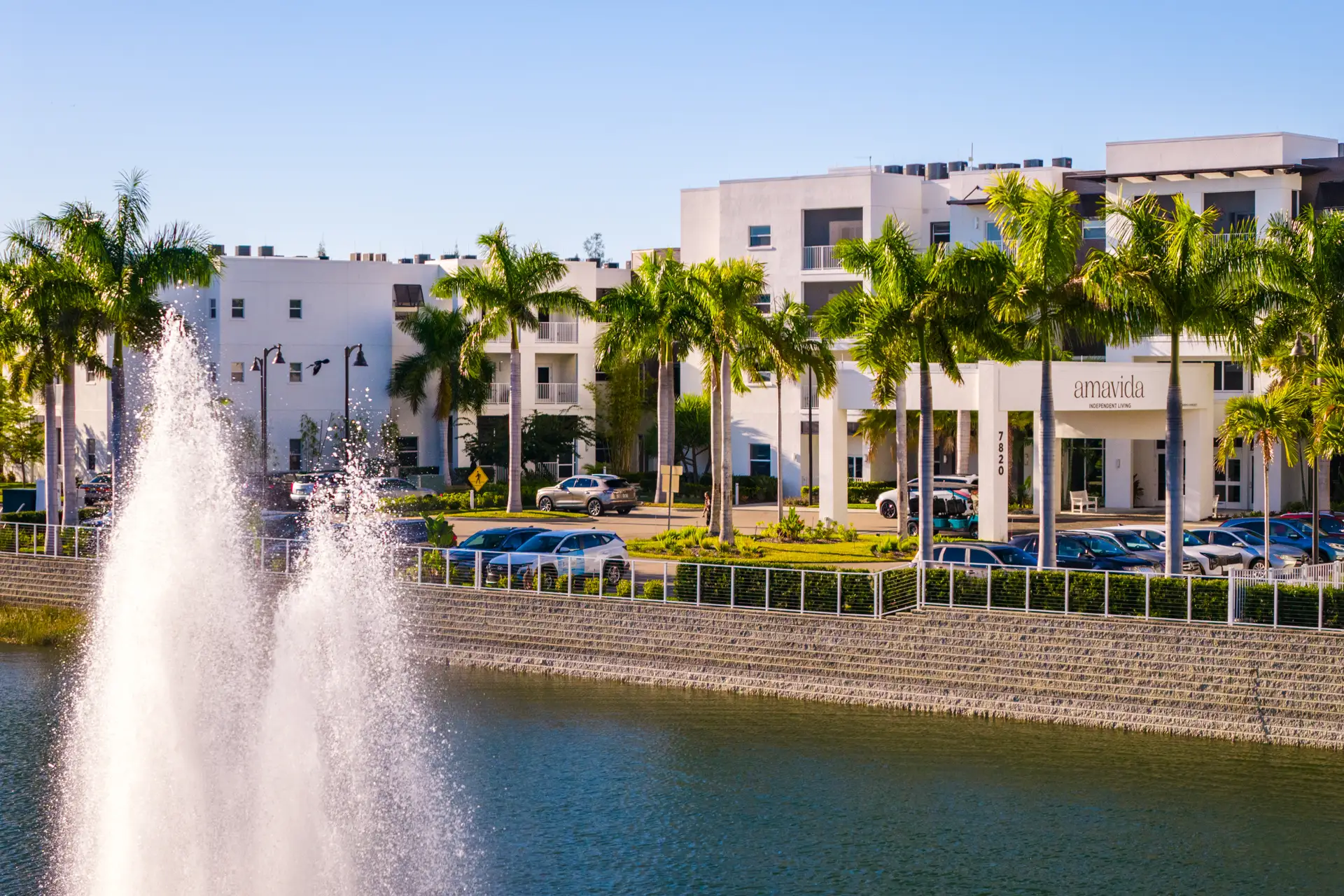 Exterior view of Amavida Senior Living with palm trees