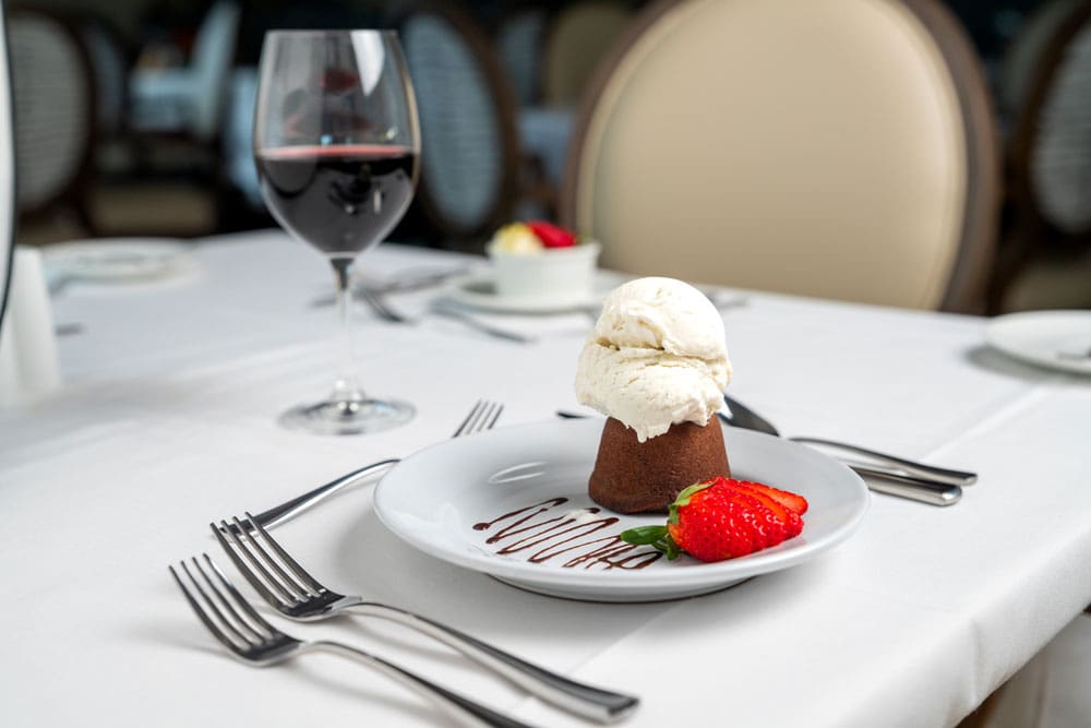 Dessert served in a dining room with wine
