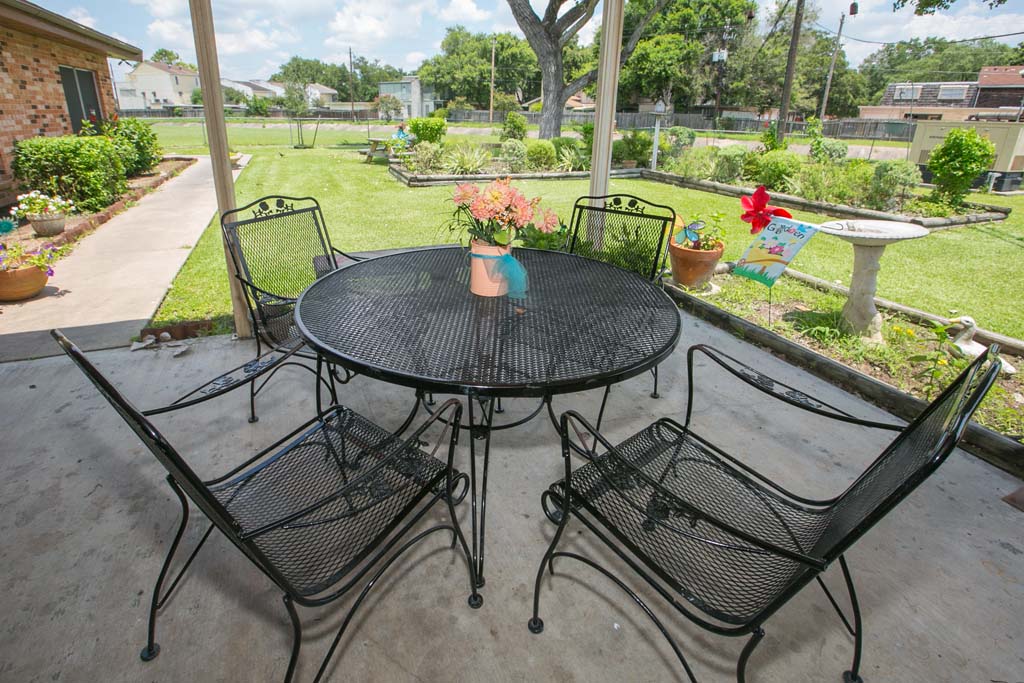Outdoor seating area with table and chairs.