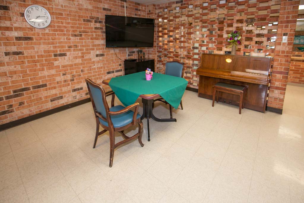Common area with piano and seating