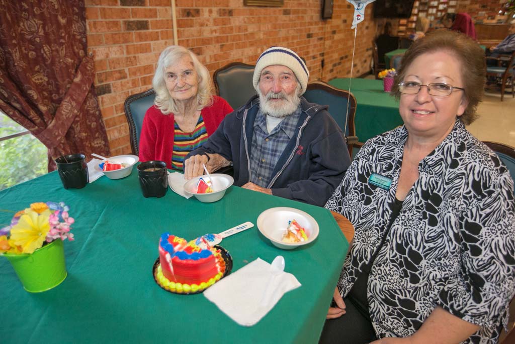 Residents and staff celebrating with cake