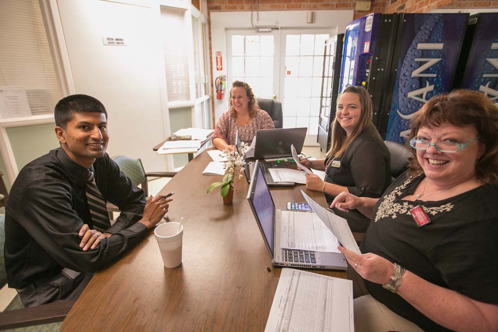Staff members working together in an office setting.